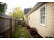Side yard with stepping stones and a wooden fence at 112 E Edgewood Dr, Durham, NC 27704