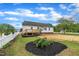 Beautiful backyard with a deck, lush greenery, and a white picket fence at 112 Edmondson Dr, Willow Springs, NC 27592
