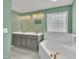 Spa-like bathroom featuring a large soaking tub, dual vanities, modern fixtures, and ample lighting at 112 Edmondson Dr, Willow Springs, NC 27592