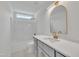 This updated bathroom includes a granite countertop vanity, shower, and gold finishes at 112 Edmondson Dr, Willow Springs, NC 27592