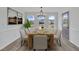 Elegant dining room with ample natural light, wood table, seating for eight, and decorative chandelier at 112 Edmondson Dr, Willow Springs, NC 27592