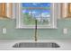 Close up of a kitchen sink with a green backsplash and stainless steel appliances for a modern touch at 112 Edmondson Dr, Willow Springs, NC 27592