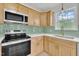 Modern kitchen featuring stainless steel appliances, light wood cabinetry, and sleek countertops at 112 Edmondson Dr, Willow Springs, NC 27592