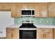 Updated kitchen with stainless steel appliances, stylish light wood cabinets, and quartz countertops at 112 Edmondson Dr, Willow Springs, NC 27592