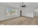 Bright living room boasts natural light with sleek ceiling fan and durable hard surface floors at 112 Edmondson Dr, Willow Springs, NC 27592