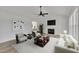 Staged living room with neutral tones, fireplace, ceiling fan, and comfortable seating arrangement at 112 Edmondson Dr, Willow Springs, NC 27592