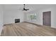 Bright living room featuring a fireplace, natural light, and a neutral color palette for comfort and style at 112 Edmondson Dr, Willow Springs, NC 27592