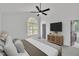 Relaxing bedroom featuring a king-size bed, ceiling fan, natural light, and ensuite bathroom at 112 Edmondson Dr, Willow Springs, NC 27592