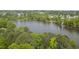Scenic aerial view of a lake bordered by lush trees and greenery at 115 White Lake Ct, Cary, NC 27519