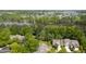 Aerial view of homes surrounded by lush greenery and a serene lake at 115 White Lake Ct, Cary, NC 27519