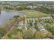 Aerial view showing a lakeside community with single Gathering homes, lake views, and landscaping at 115 White Lake Ct, Cary, NC 27519