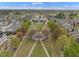 Drone view of a neighborhood with a well-maintained park, walking paths, and community amenities at 115 White Lake Ct, Cary, NC 27519