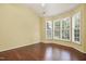 Bedroom featuring hardwood flooring and large windows with plantation shutters at 115 White Lake Ct, Cary, NC 27519