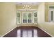 Dining area with hardwood flooring, plantation shutters, and a modern chandelier at 115 White Lake Ct, Cary, NC 27519
