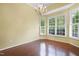 Dining area with natural light, featuring hardwood floors, chandelier, and plantation shutters at 115 White Lake Ct, Cary, NC 27519