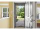 Inviting entryway reveals a glimpse of the lush backyard through a storm door at 115 White Lake Ct, Cary, NC 27519