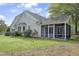 Home exterior showcasing the screened-in porch and well-manicured lawn at 115 White Lake Ct, Cary, NC 27519