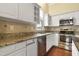Bright kitchen with stainless steel appliances, granite counters, and ample cabinet space at 115 White Lake Ct, Cary, NC 27519