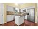 Modern kitchen features stainless steel appliances, granite countertops, and an island at 115 White Lake Ct, Cary, NC 27519