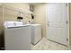 Laundry area includes washer, dryer, and storage shelves at 115 White Lake Ct, Cary, NC 27519