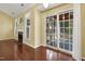 Open-plan living area featuring hardwood floors, fireplace, and sliding door access to the sunroom at 115 White Lake Ct, Cary, NC 27519