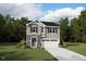 Charming two-story home with stone accents, gray siding, a manicured lawn, and a two-car garage at 120 Sprenger St, Garner, NC 27529