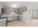 Full kitchen view of the grey cabinets, stainless steel appliances and eat-in area at 1205 Freeman Dr, Sanford, NC 27330