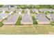 Scenic aerial perspective of the backyard views and house roofs in a well planned residential community at 122 Tall Timber Dr, Gibsonville, NC 27249