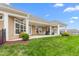 Large backyard with a covered patio and lush green grass, perfect for outdoor activities and relaxation at 122 Tall Timber Dr, Gibsonville, NC 27249