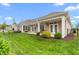 Expansive backyard featuring a covered patio and well-manicured landscaping and a black metal fence at 122 Tall Timber Dr, Gibsonville, NC 27249