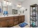 Bathroom showcasing a double vanity with warm wood cabinetry and lots of counter space at 122 Tall Timber Dr, Gibsonville, NC 27249