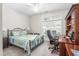 Comfortable bedroom with a ceiling fan, desk, and a window overlooking the yard at 122 Tall Timber Dr, Gibsonville, NC 27249