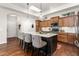 A kitchen with bar stools around the island, skylights, wooden cabinets, and stainless steel appliances at 122 Tall Timber Dr, Gibsonville, NC 27249