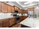 The kitchen has wooden cabinets and stainless steel appliances, plus a skylight adding natural light at 122 Tall Timber Dr, Gibsonville, NC 27249