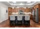 A kitchen featuring an island with bar stools, skylights, wooden cabinets, and stainless steel appliances at 122 Tall Timber Dr, Gibsonville, NC 27249