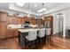 This is a kitchen featuring an island with bar stools, skylights, wooden cabinets, and stainless steel appliances at 122 Tall Timber Dr, Gibsonville, NC 27249