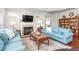 Cozy living room with a fireplace, soft rug, and comfortable seating at 122 Tall Timber Dr, Gibsonville, NC 27249