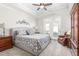 Bright main bedroom offers a ceiling fan, plush carpet, and French doors to the yard at 122 Tall Timber Dr, Gibsonville, NC 27249