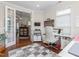 Sewing room featuring hardwood floors, sewing machine, storage cabinets, and view of living room at 122 Tall Timber Dr, Gibsonville, NC 27249