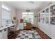 Bright sewing room with hardwood floors, a sewing machine, storage cabinets and a window at 122 Tall Timber Dr, Gibsonville, NC 27249