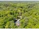 Aerial view highlighting the home's private location surrounded by lush trees and a long driveway at 12200 Glenlivet Way, Raleigh, NC 27613