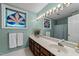 Bathroom featuring a double sink vanity, unique sconces, and a decorative stained glass window at 12200 Glenlivet Way, Raleigh, NC 27613