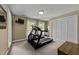 Carpeted bedroom with exercise equipment and walk-in closet at 12200 Glenlivet Way, Raleigh, NC 27613