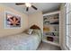 Comfortable carpeted bedroom with built-in bookshelves, single bed, and stained glass window at 12200 Glenlivet Way, Raleigh, NC 27613