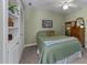 Bedroom with carpet, ceiling fan, and built-in shelving at 12200 Glenlivet Way, Raleigh, NC 27613