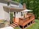 Multi-level deck with a dining area, hot tub, and stairs leading to the yard; ideal for outdoor living at 12200 Glenlivet Way, Raleigh, NC 27613