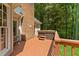 Back deck featuring a hot tub and brick chimney, perfect for outdoor relaxation at 12200 Glenlivet Way, Raleigh, NC 27613