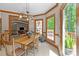 Bright dining room with wood trim, access to the deck, and open to the living room at 12200 Glenlivet Way, Raleigh, NC 27613