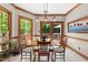 Charming dining area with wood trim, large windows, and access to outdoor deck at 12200 Glenlivet Way, Raleigh, NC 27613
