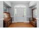 Welcoming foyer with a hardwood floor, arched front door, and classic furnishings at 12200 Glenlivet Way, Raleigh, NC 27613